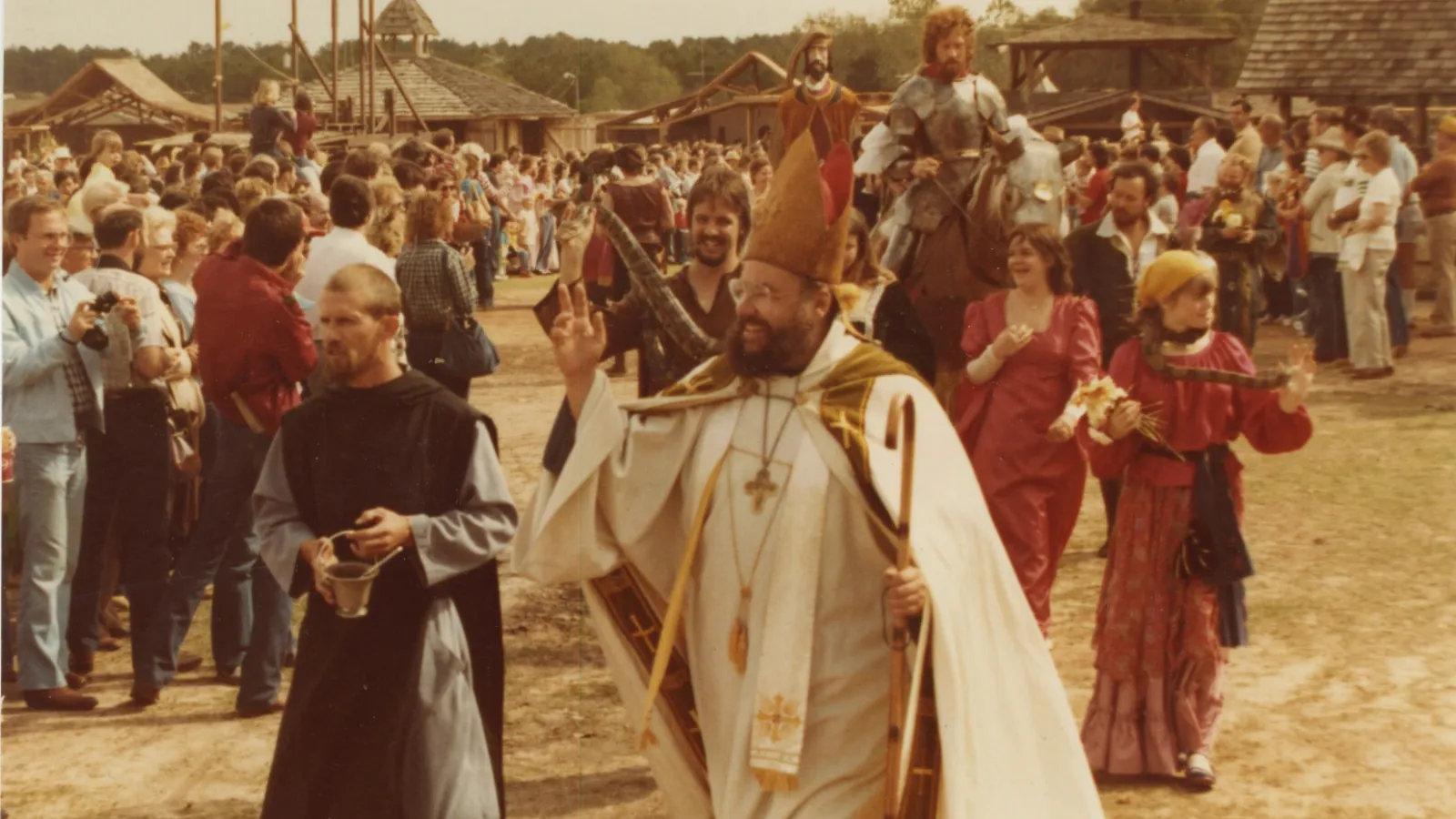 a group of people standing in front of a crowd posing for the camera