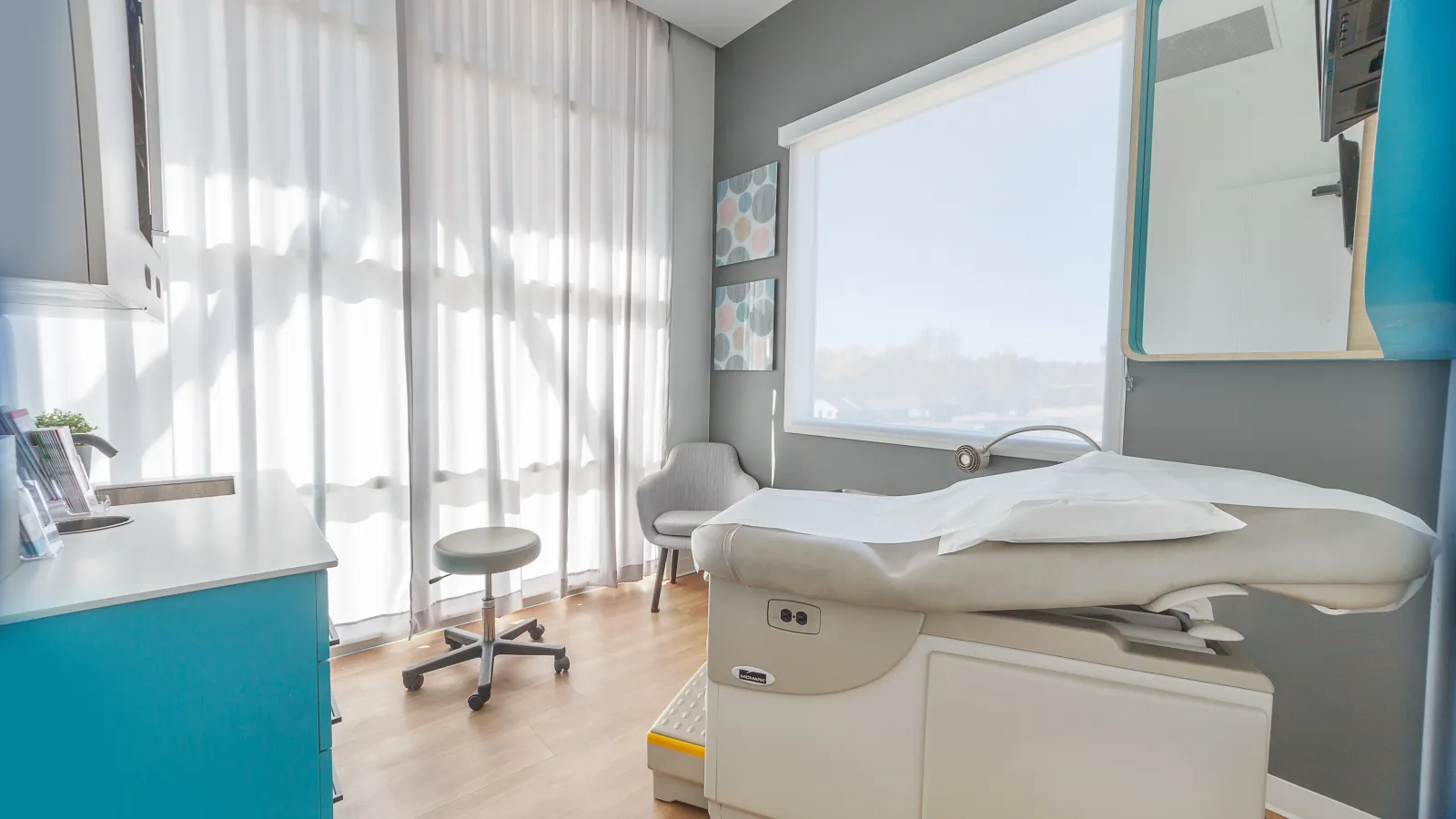 a doctor office with a bed and a chair