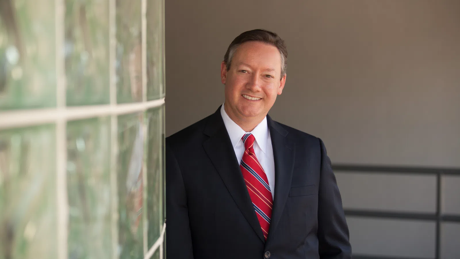 a man in a suit smiling