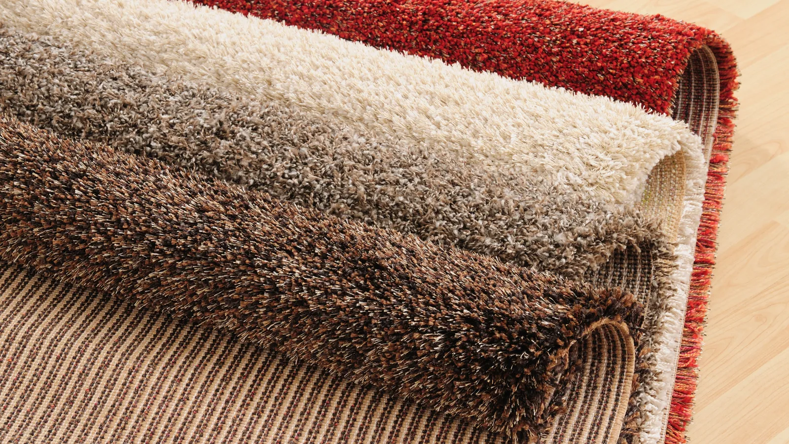 Stylish collection of plush area rugs in various colors and textures, perfect for home decor.