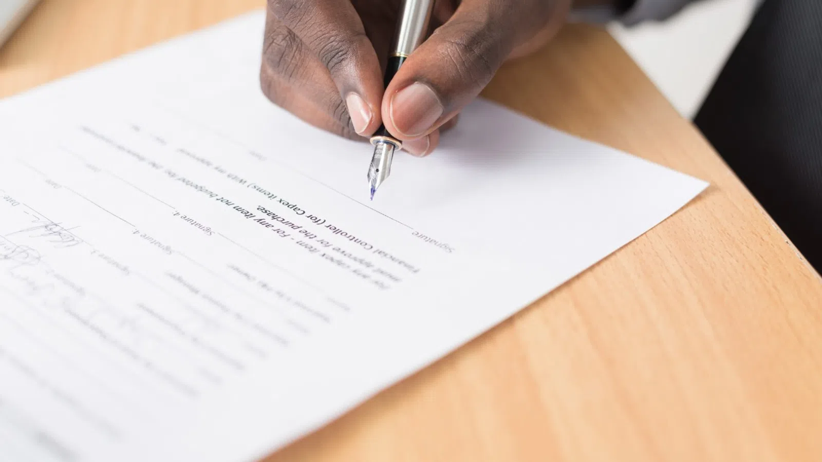 a man signing paper
