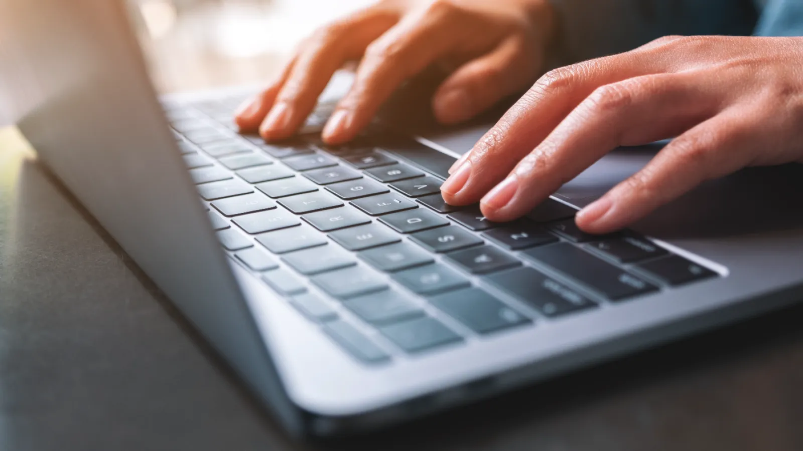 a person typing on a laptop