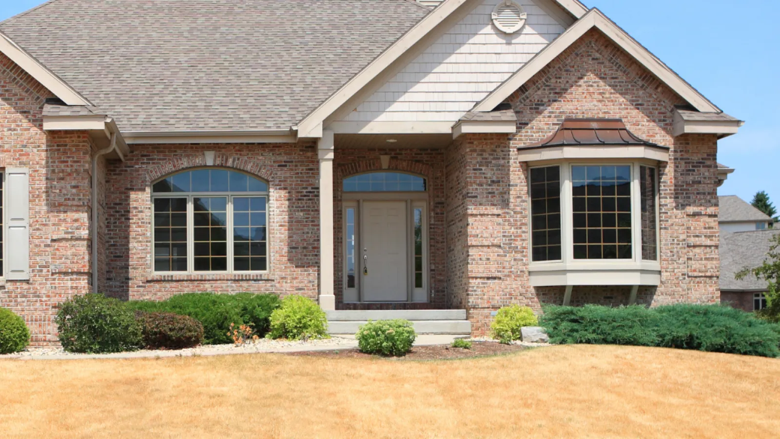 a brick house with a driveway