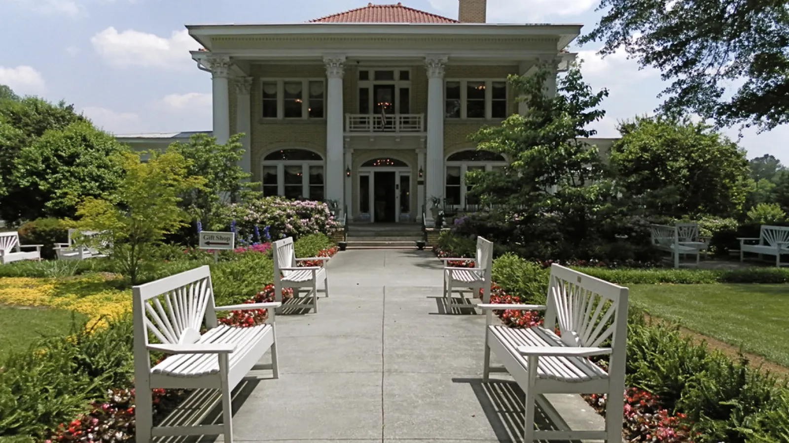 pretty house with seats out front