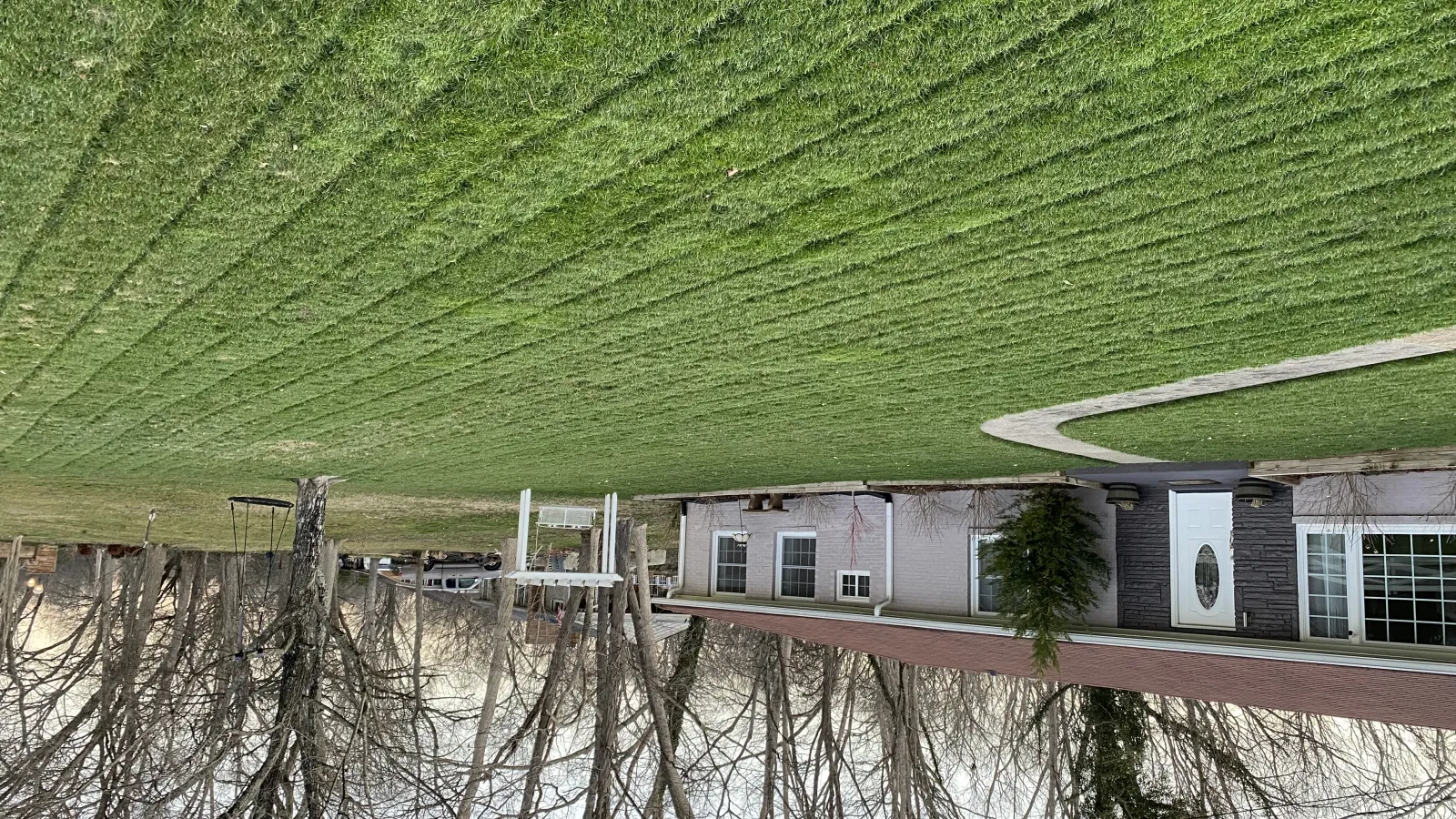 a house with a green field in the background