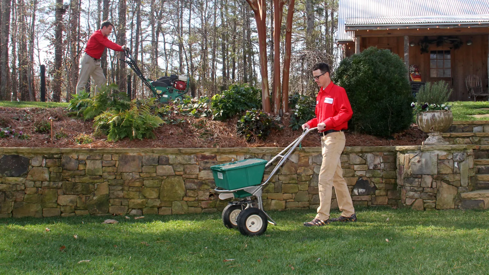 team member core aerating and seeding a lawn