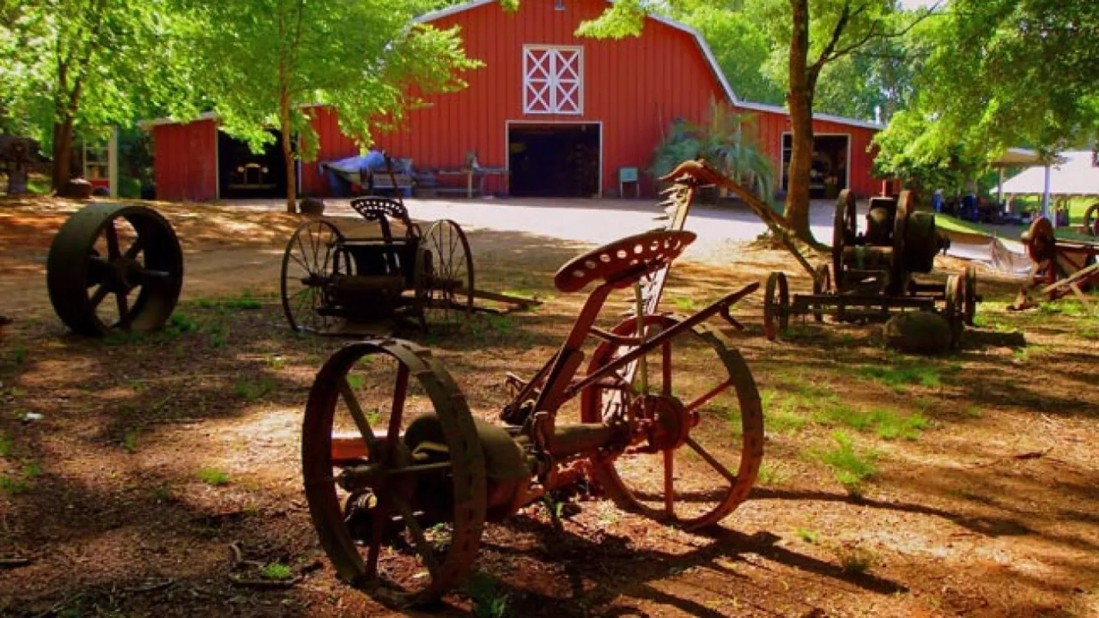 old equipment and red barn
