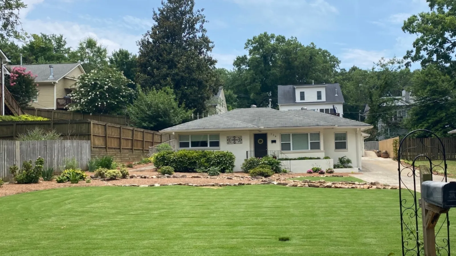 a backyard with a fence and a house