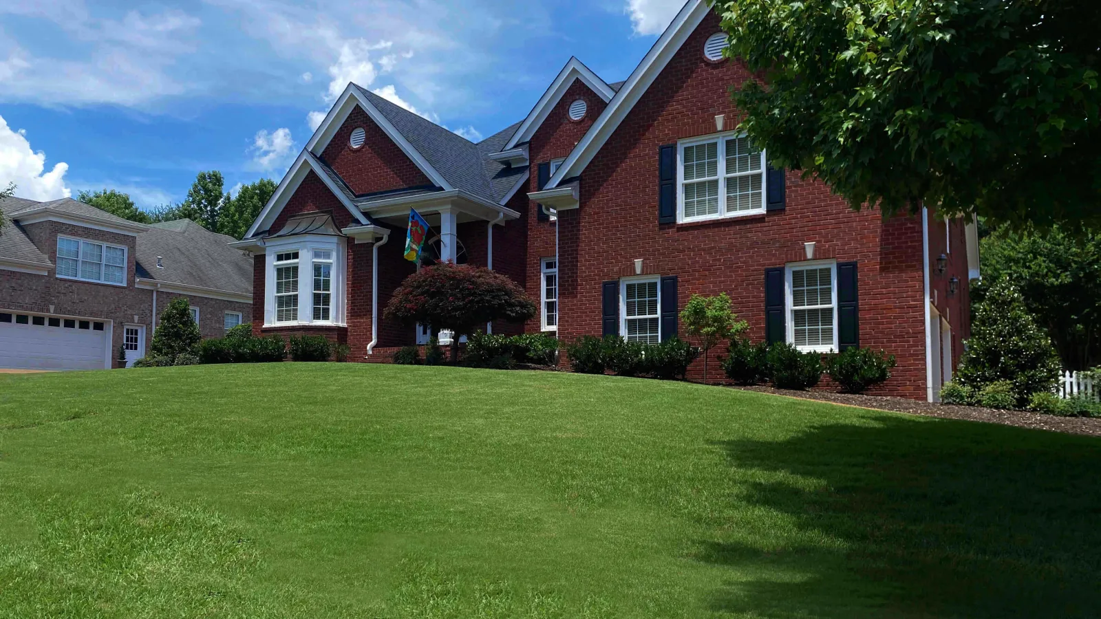 brick home with pretty grass