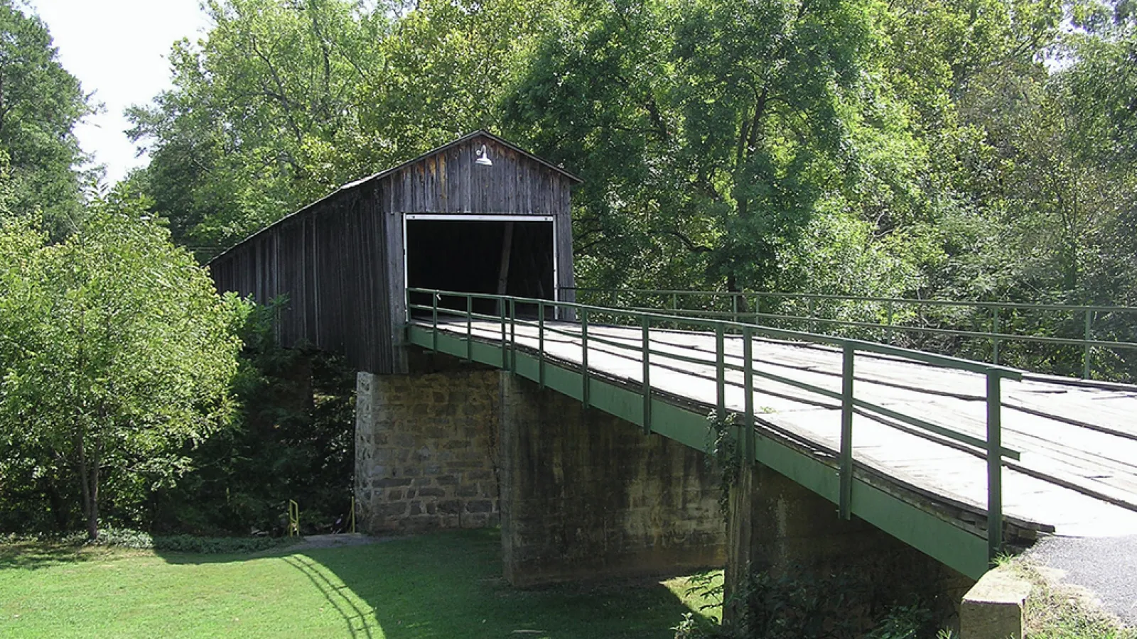 Bridge with a tunnel surrounded by grennery