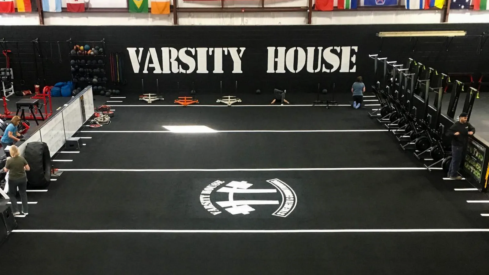 a group of people standing on a track with a sign on it