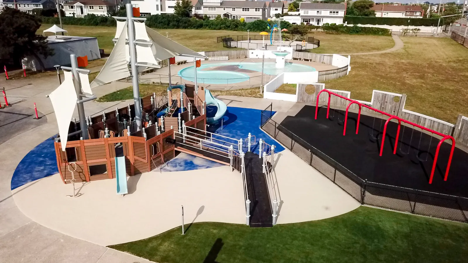 a pool with a slide and a slide in a park