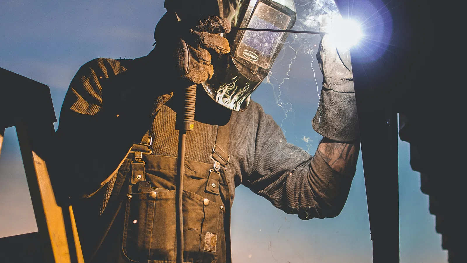 a man wearing a helmet and holding a light saber