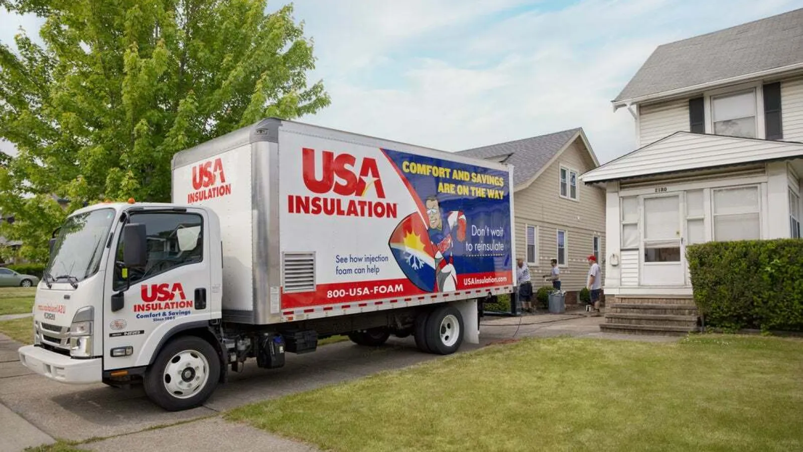 USA Insulation truck parked outside a residential home, promoting foam insulation services.