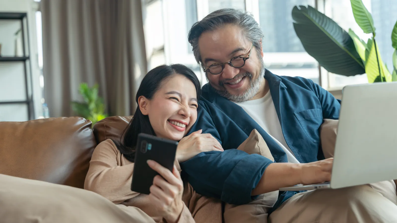 a man and a woman looking at a laptop