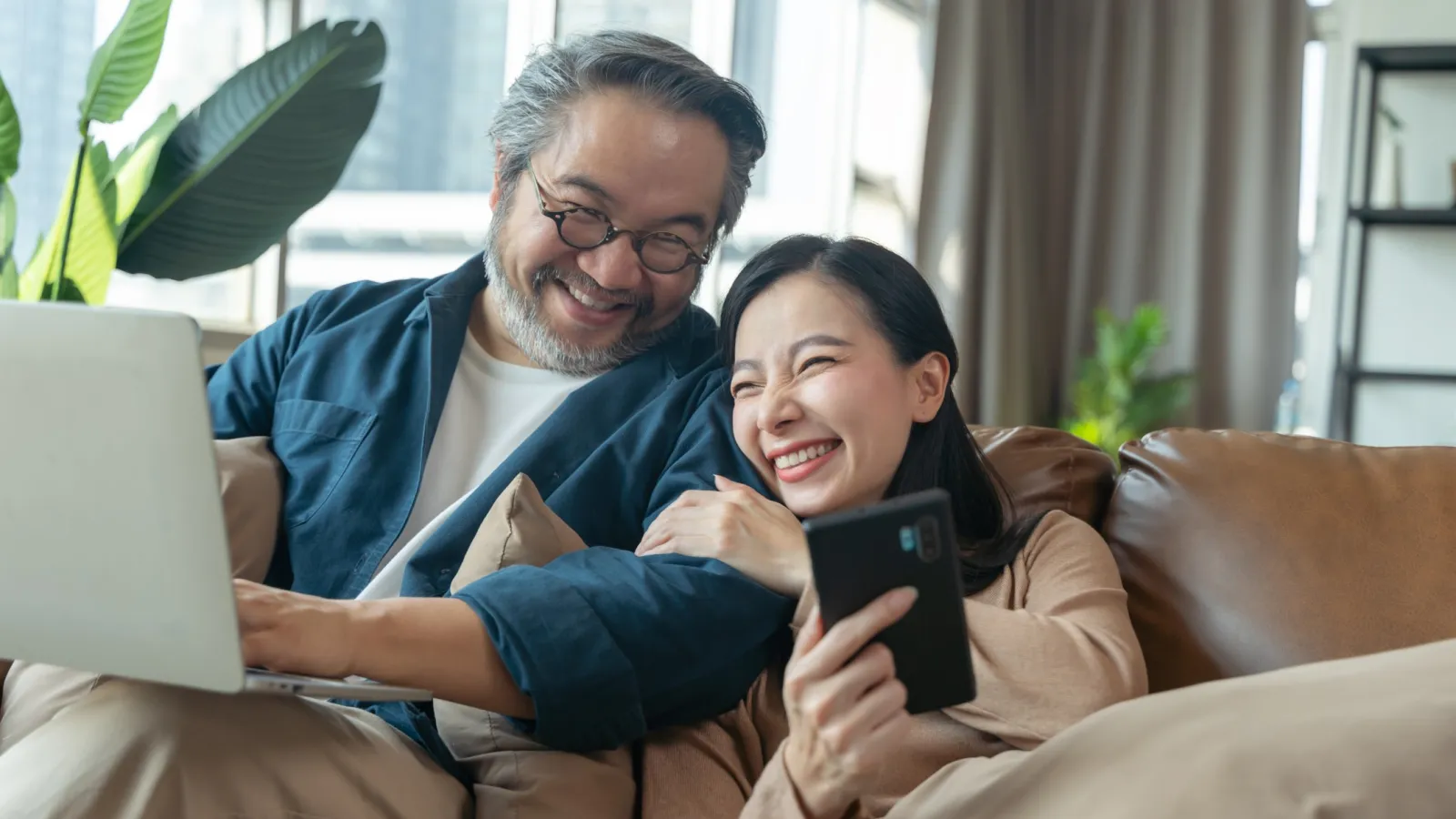 a man and a woman looking at a laptop