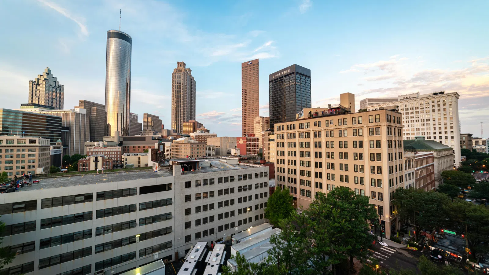 View of Atlanta skyline at sunset featuring modern skyscrapers and historic buildings with clear sky.