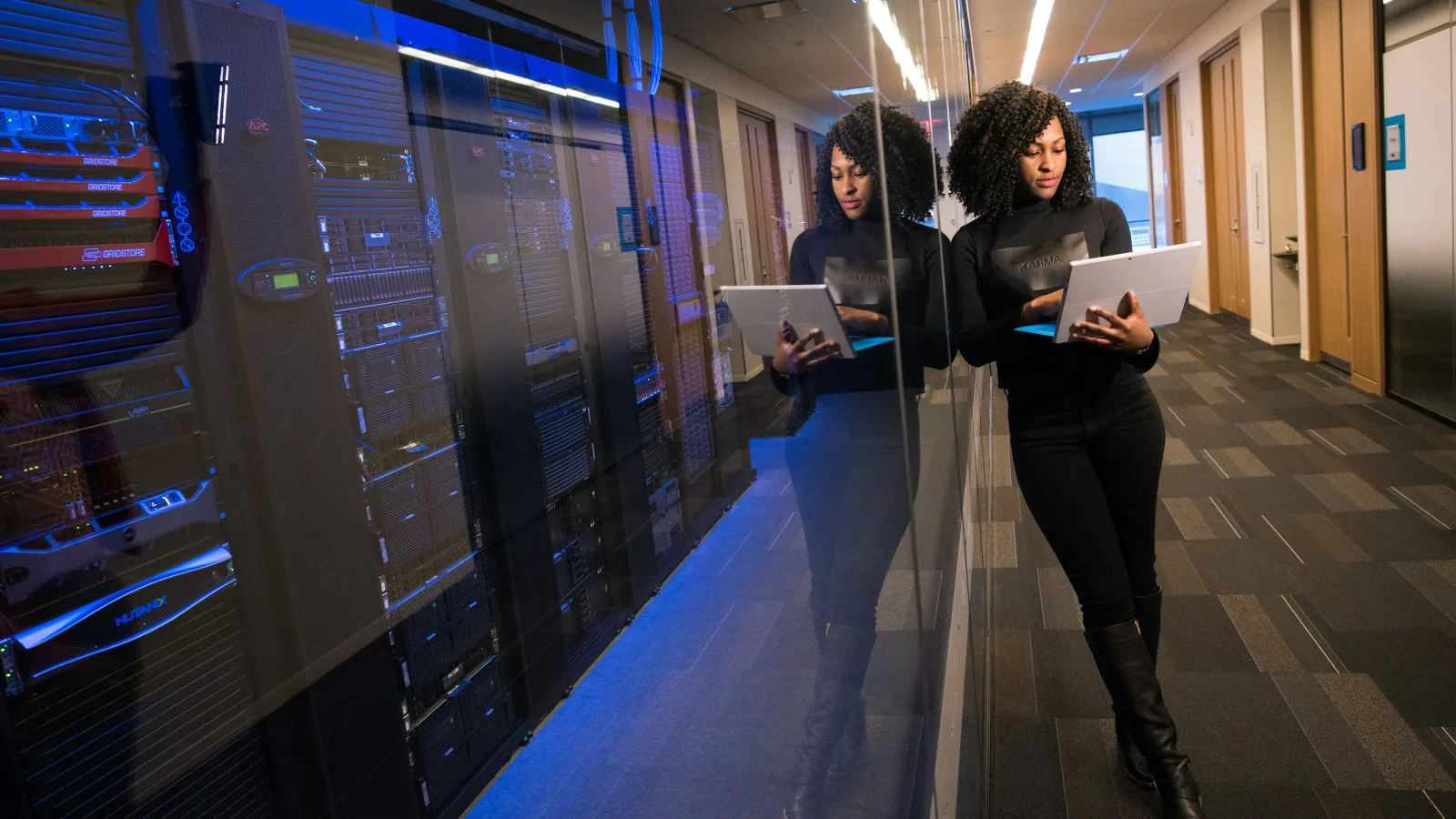 a few people working in a server room