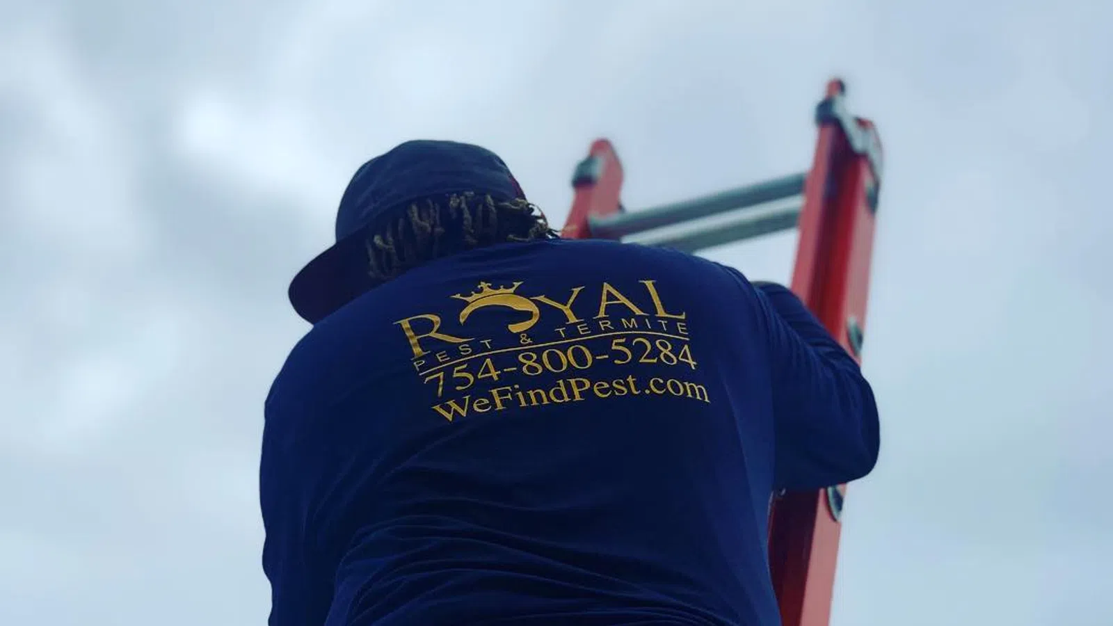 Technician wearing Royal Pest & Termite shirt climbing a red ladder against a cloudy sky background.