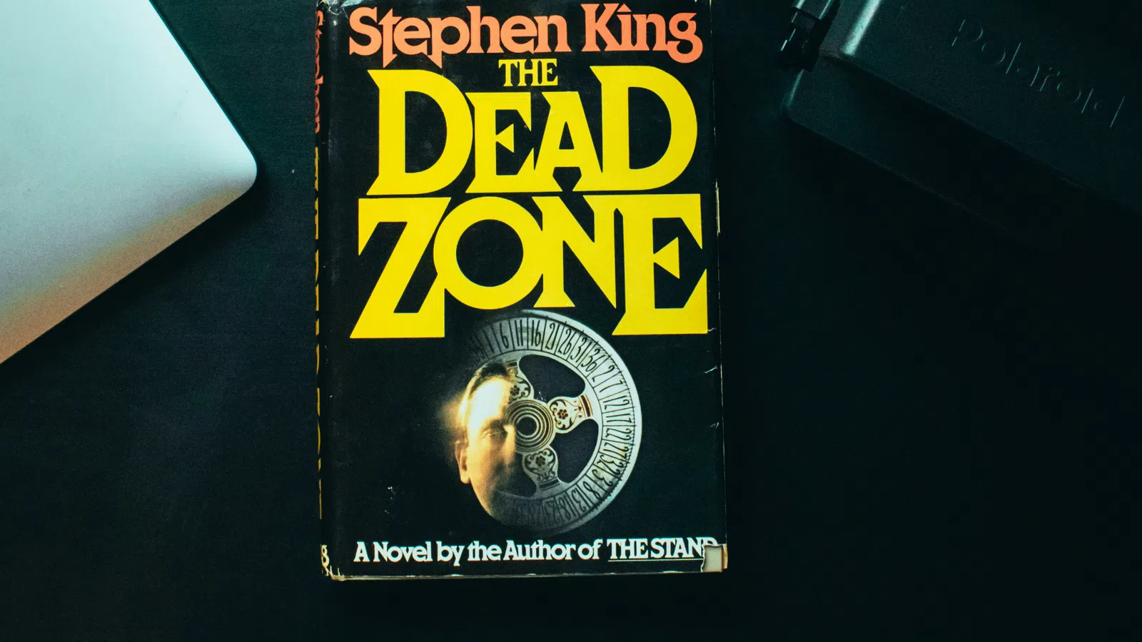 Stephen King’s novel The Dead Zone with overlaid title text in yellow on a black book cover.