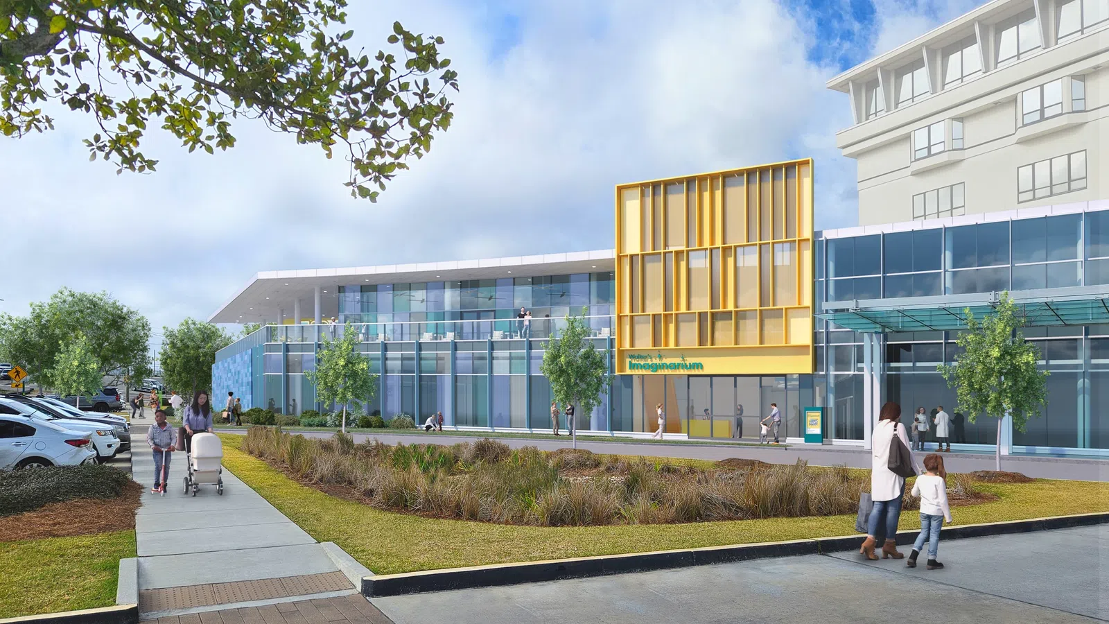 Modern imaging center with glass facade, yellow accent panels, landscaped front, and people walking outside.