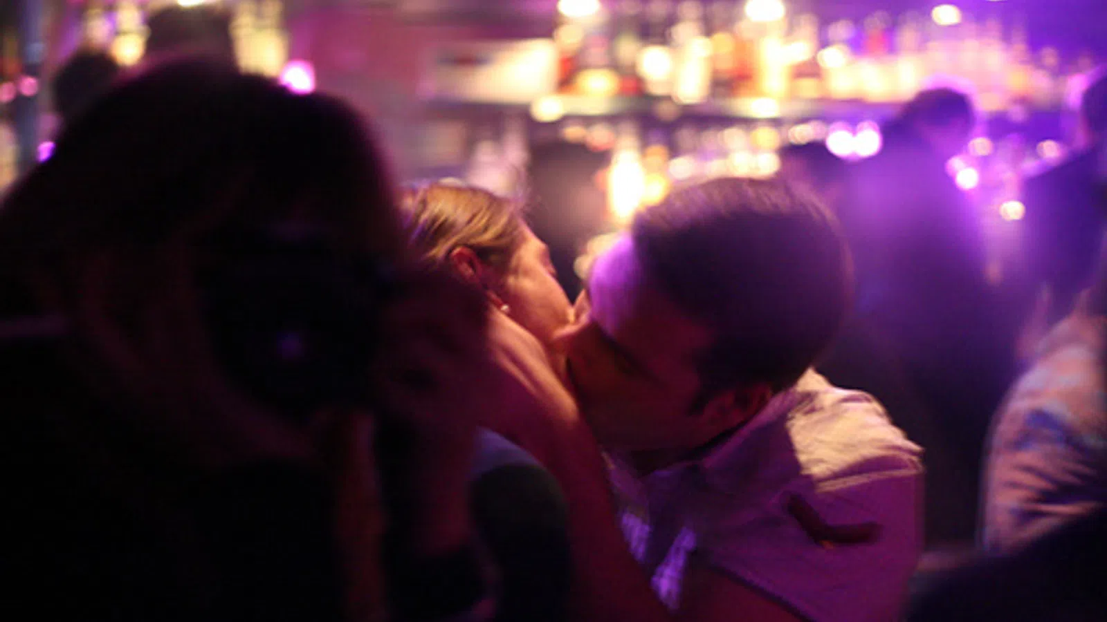 Kissing Couple Completely Oblivious to Armed Robbery Happening Nearby