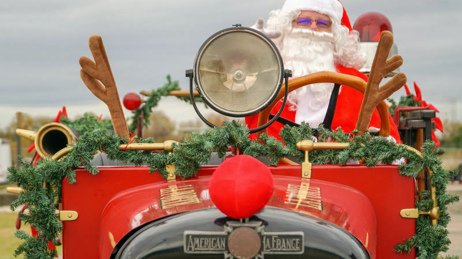 a red truck with a large christmas tree and a large silver ball