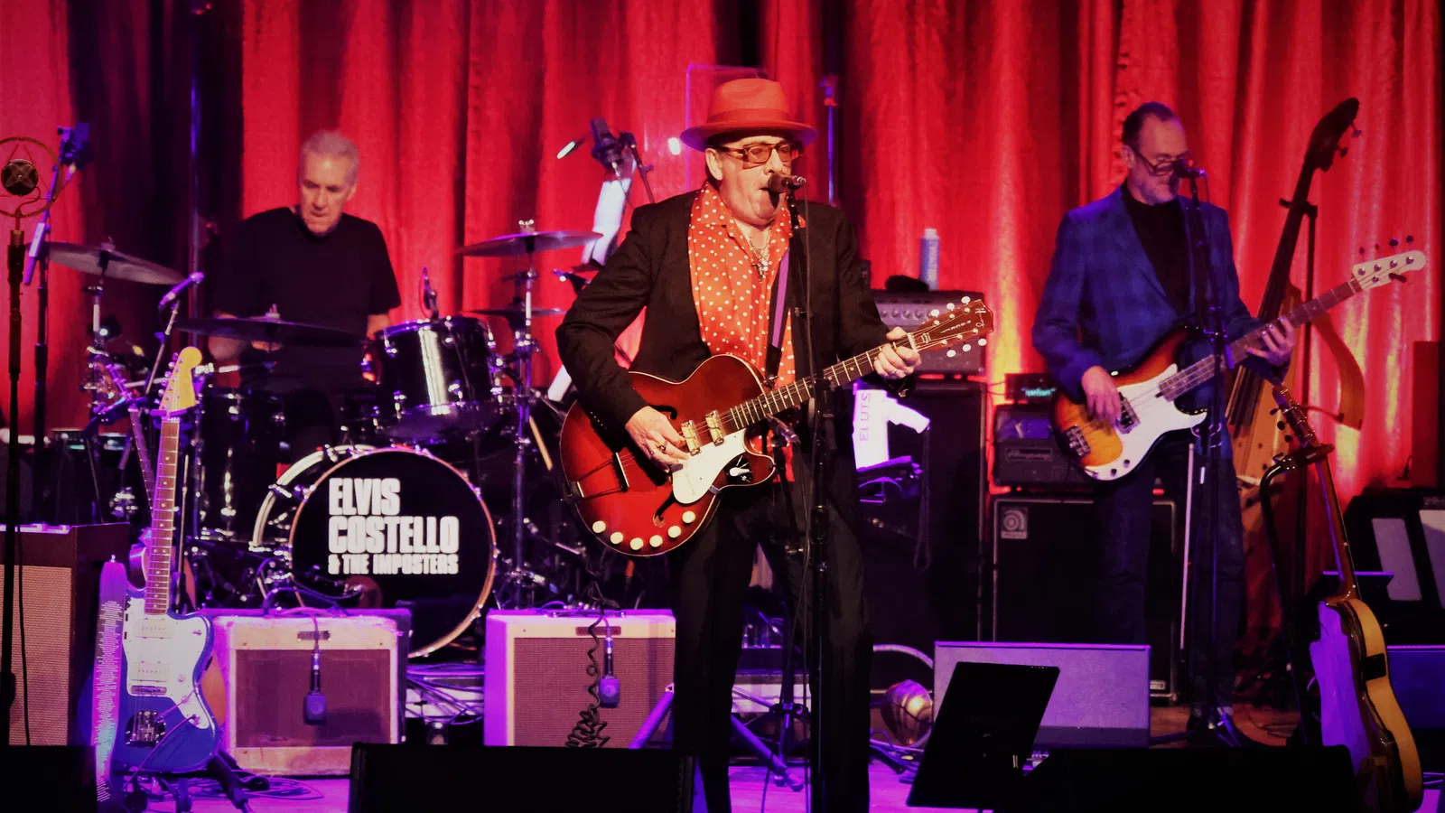 a group of men playing instruments on a stage