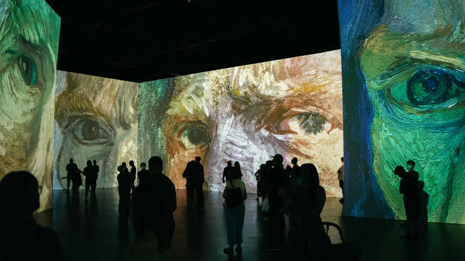 a group of people looking at a large piece of art