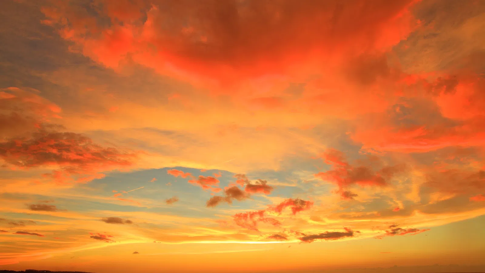 a colorful sky over a beach
