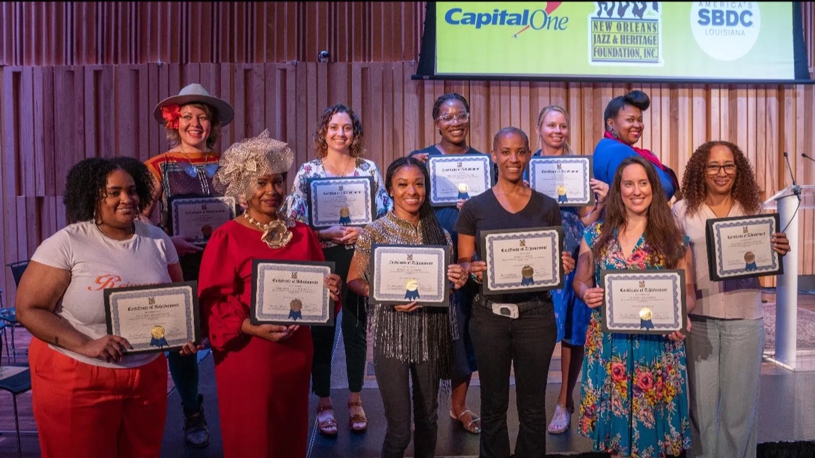 a group of people holding certificates