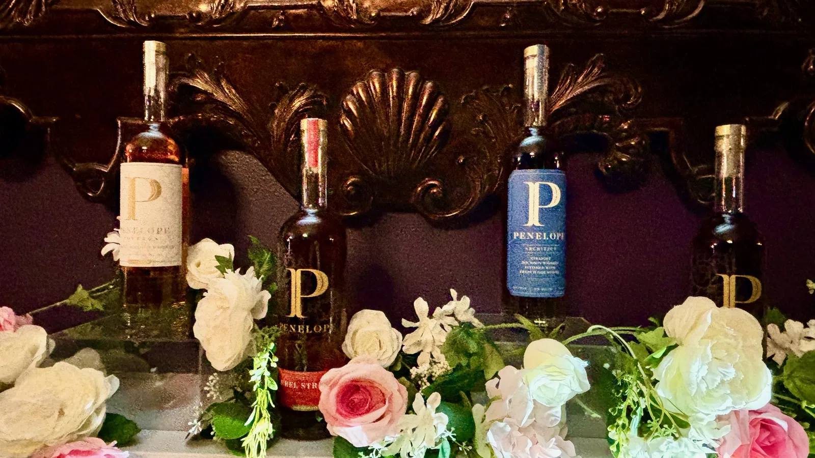 a table with bottles of wine and flowers