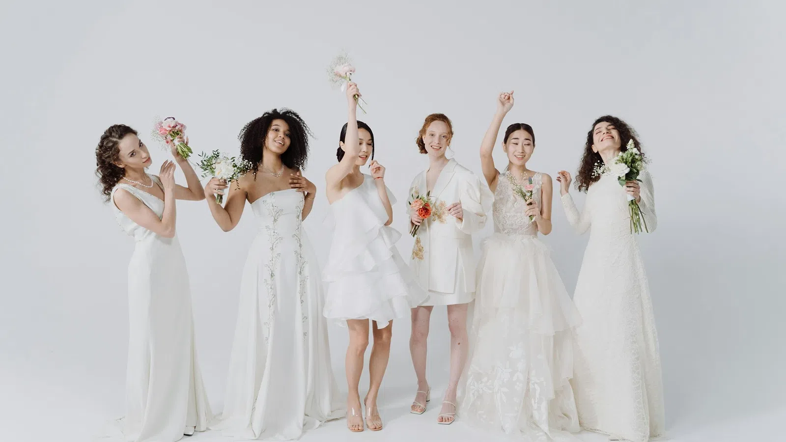 a group of women in white dresses