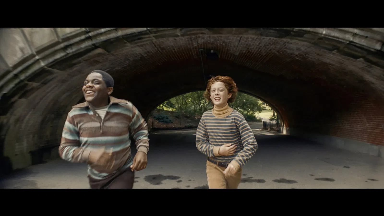 a man and woman standing in a tunnel