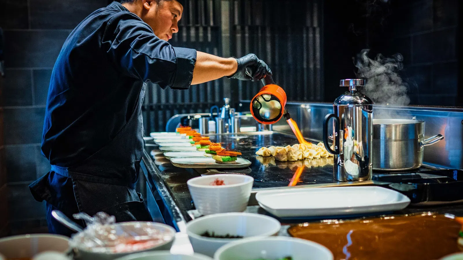 a person cooking food in a kitchen