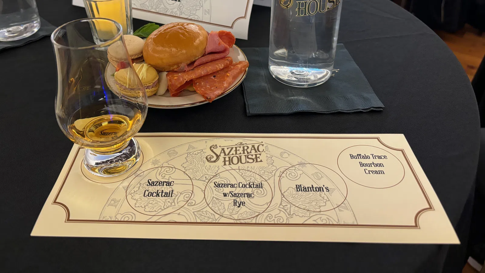 a table with plates of food and glasses of beer