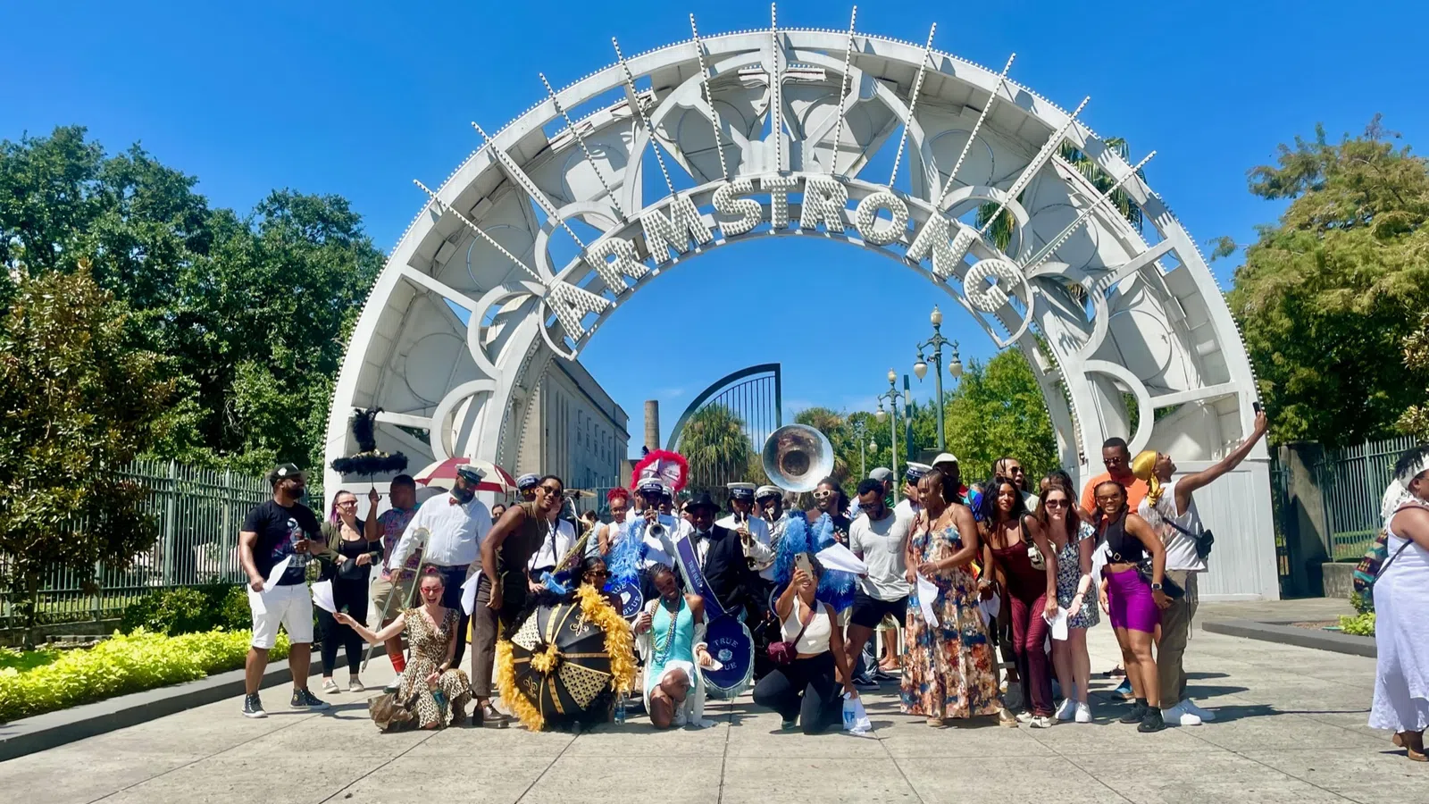 a group of people posing for a photo in front of a large structure