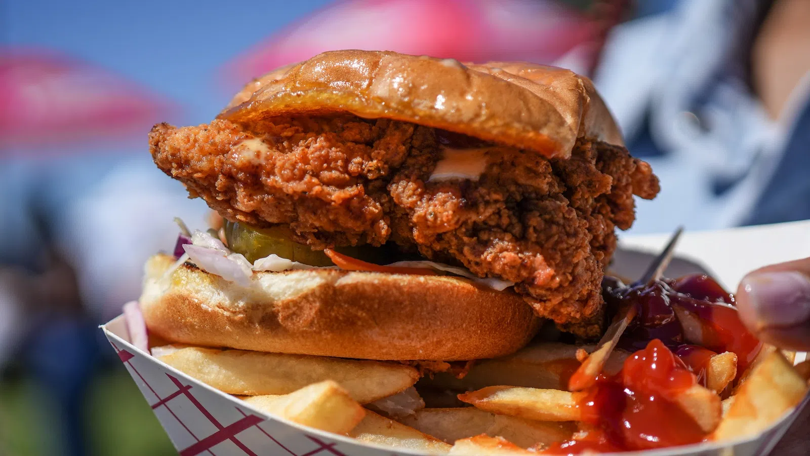 a person holding a burger