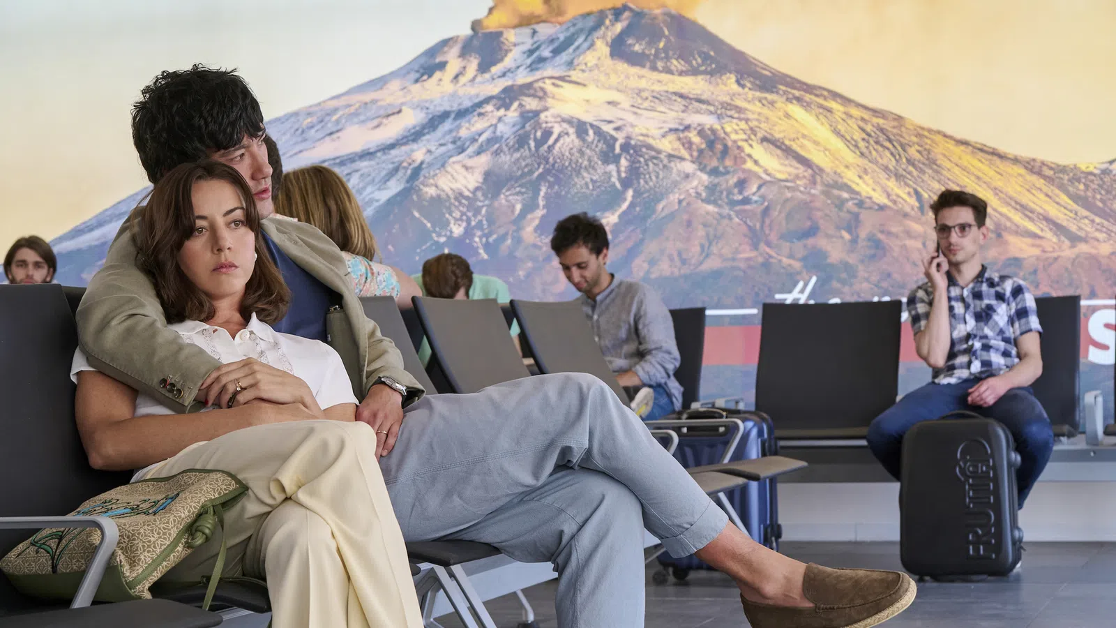 Aubrey Plaza et al. sitting in chairs with laptops
