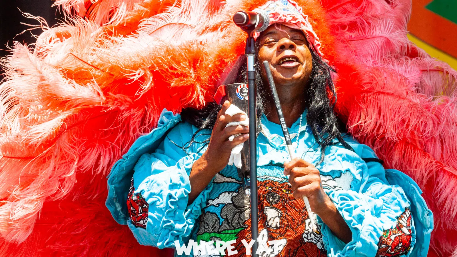 a person wearing a garment and holding a microphone
