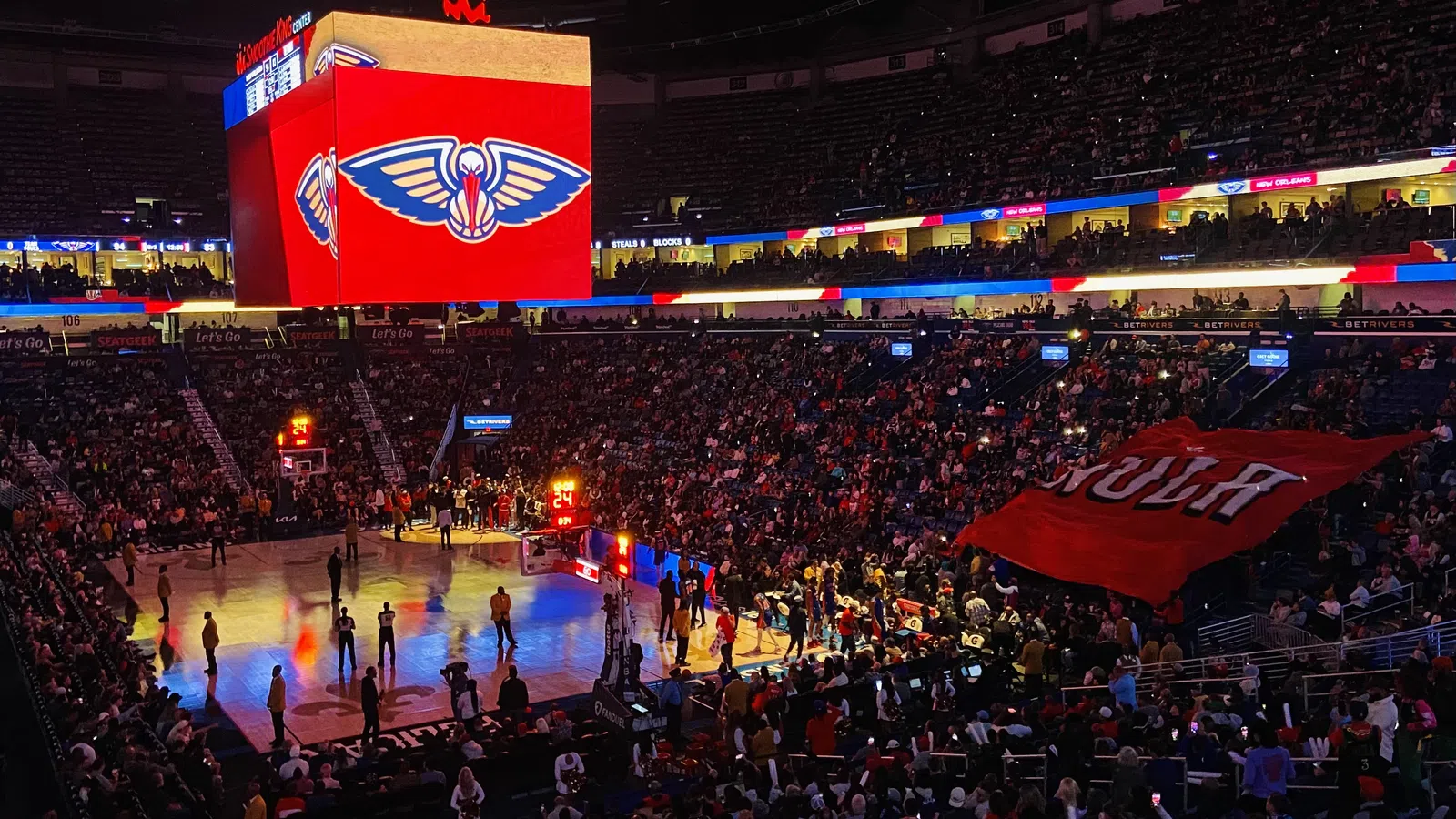 a basketball court with a crowd of people in the stands