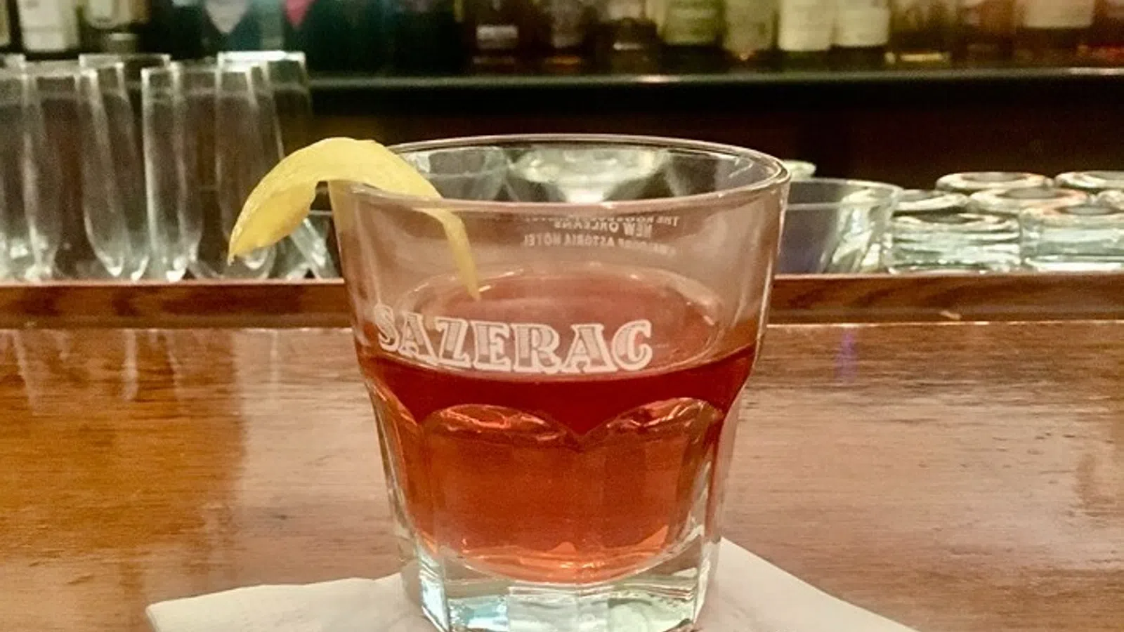 a glass of beer on a bar