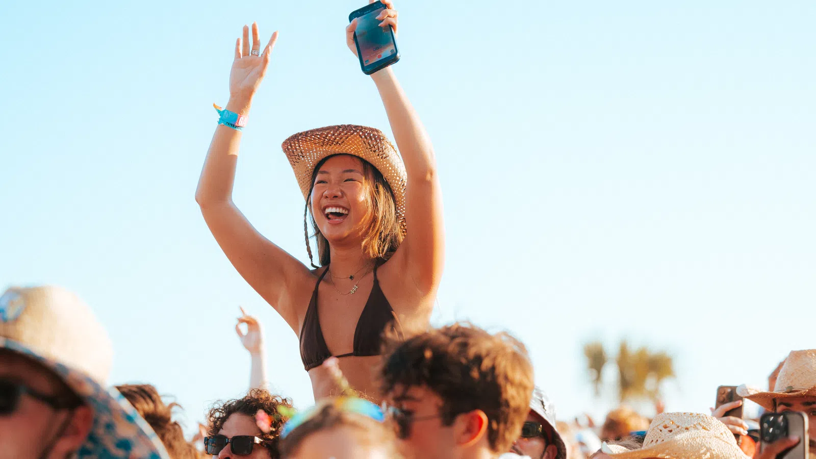 a person with a hat and a crowd of people