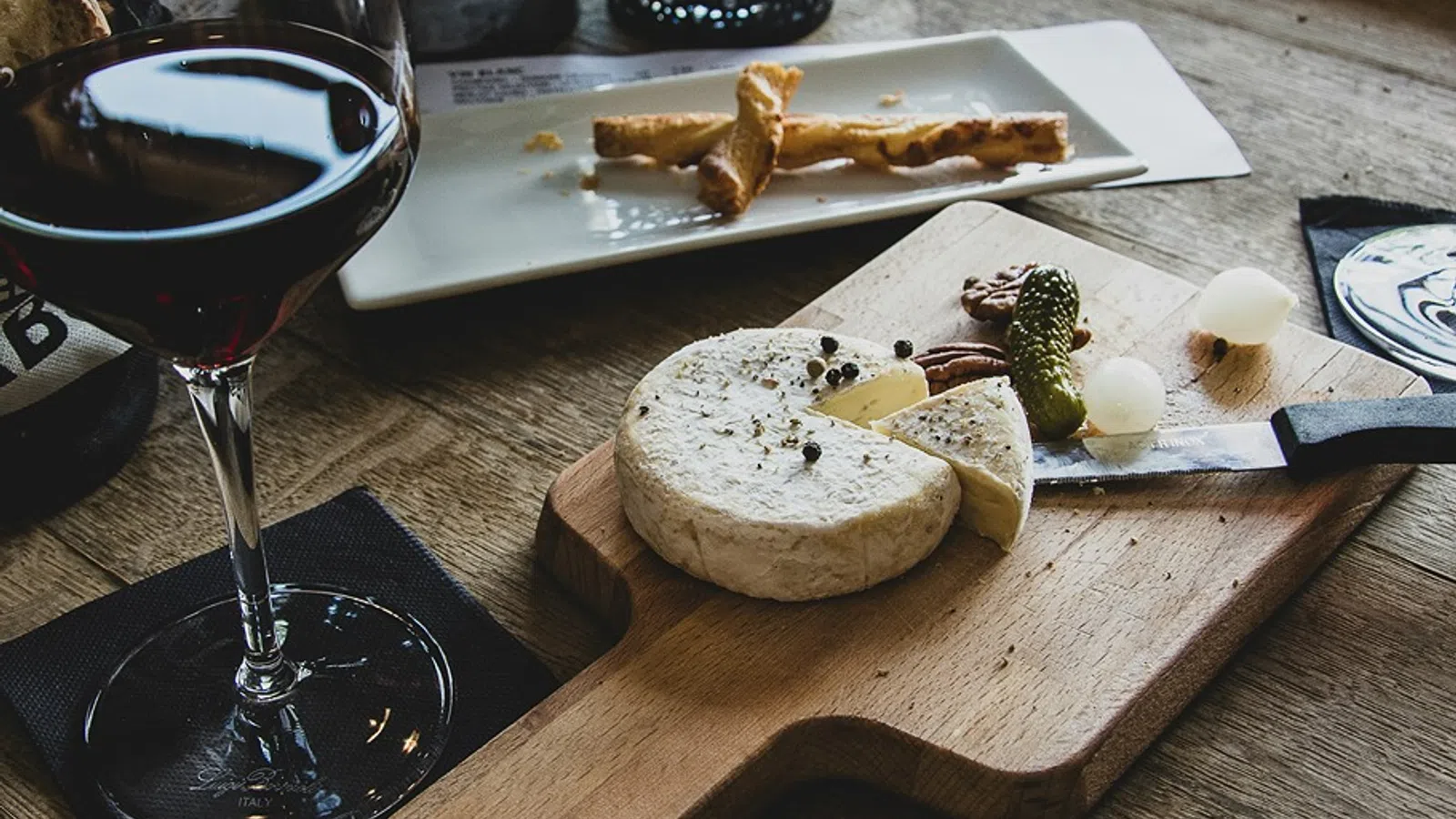 a plate of food and a glass of wine