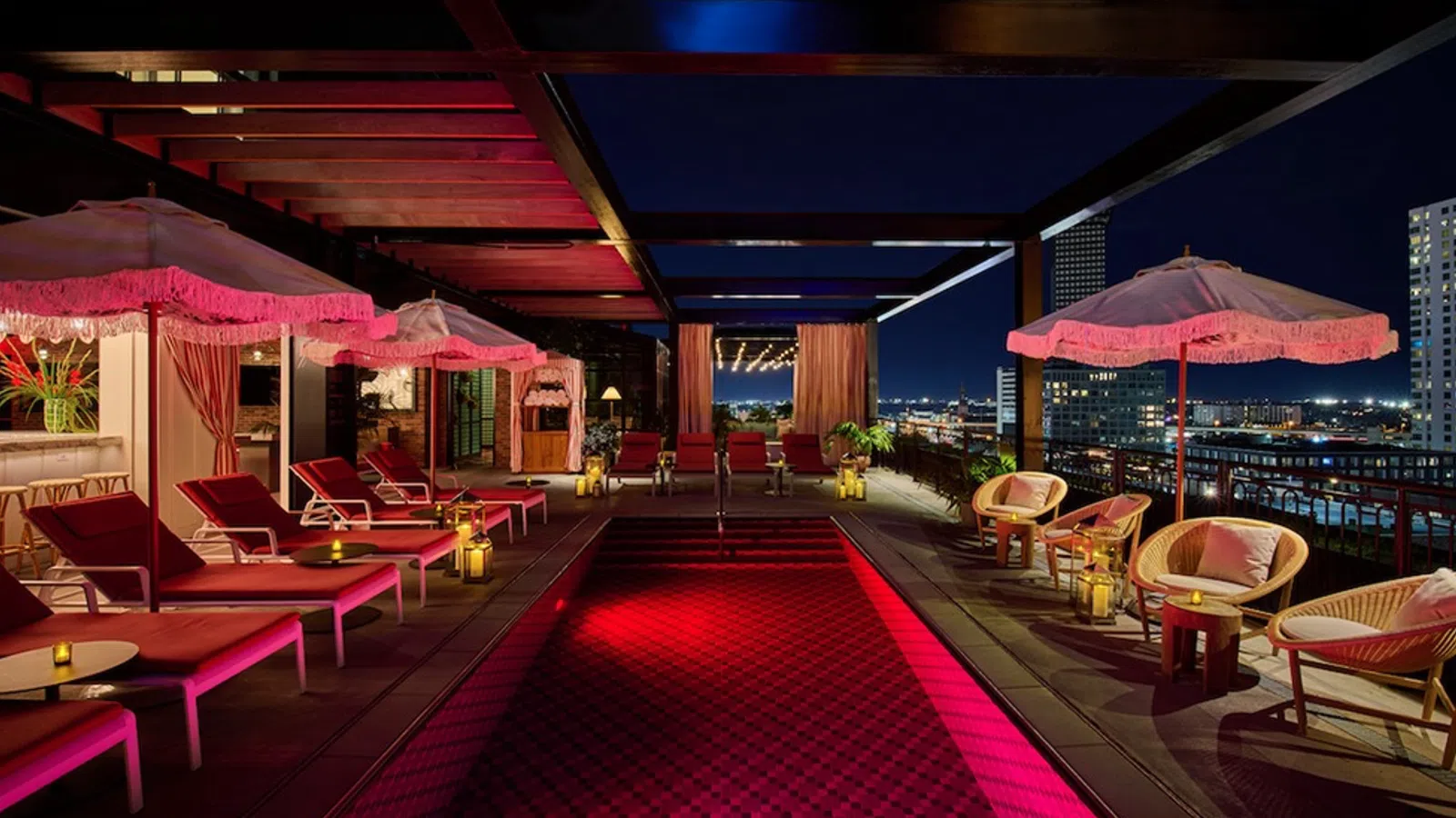 a red and white lounge area with pink umbrellas