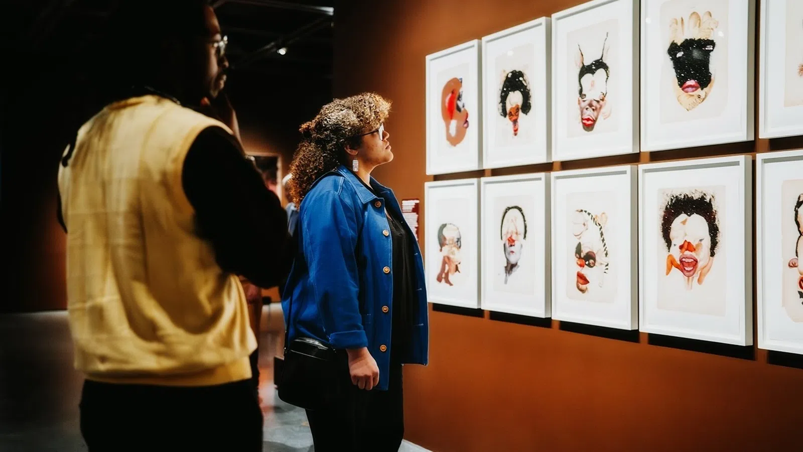 a man and woman looking at art