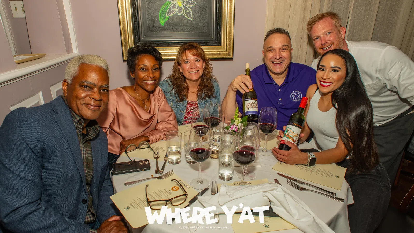 Billy Ceravolo et al. sitting around a table with wine glasses