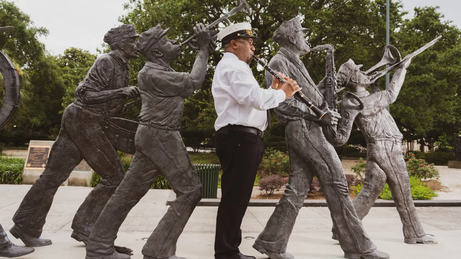 a person standing next to a statue