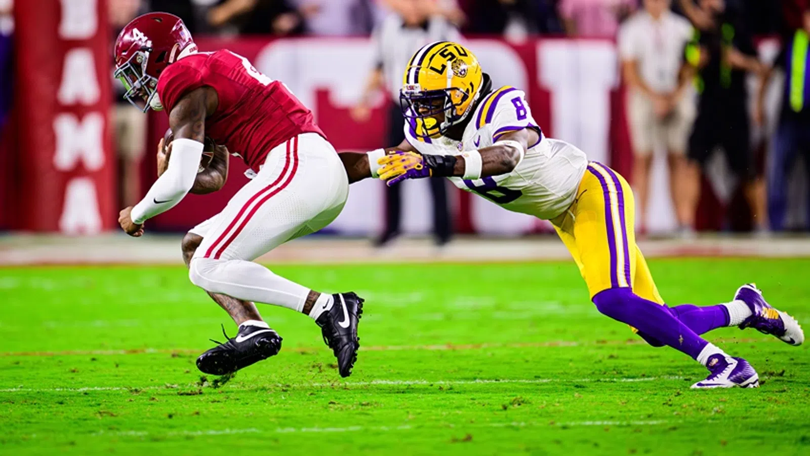 a football player tackling another football player