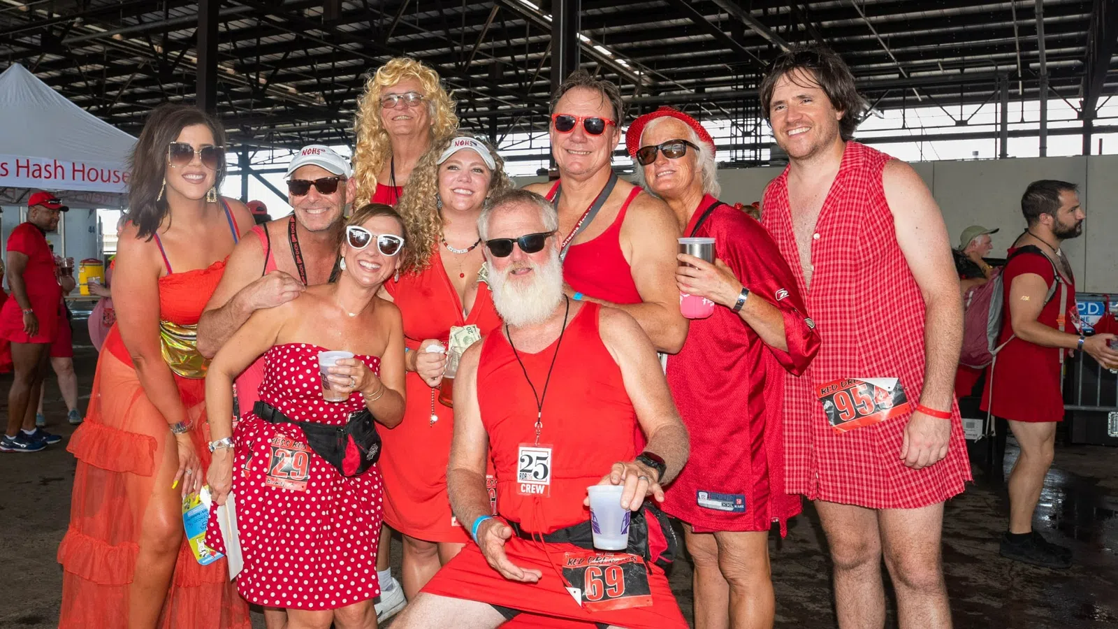 a group of people wearing red dresses